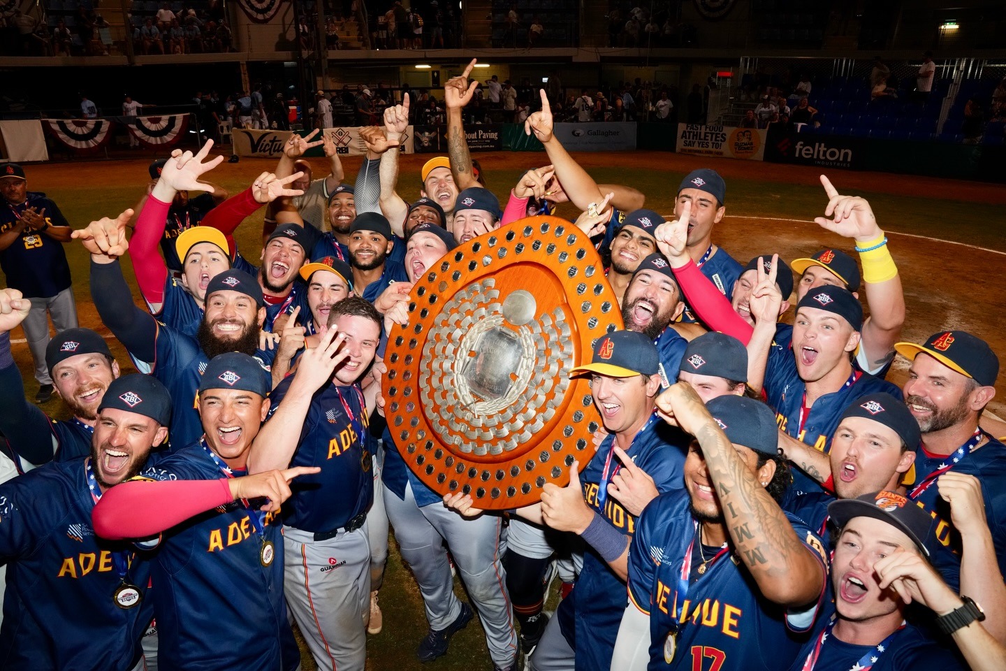 Adelaide Giants players celebrating with the ABL championship shield after defeating the Sydney Blue Sox