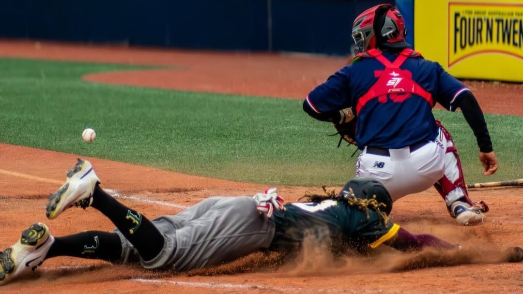 Down Under Travellers score a run against the Melbourne Aces during the College Challenge Series at Melbourne Ballpark