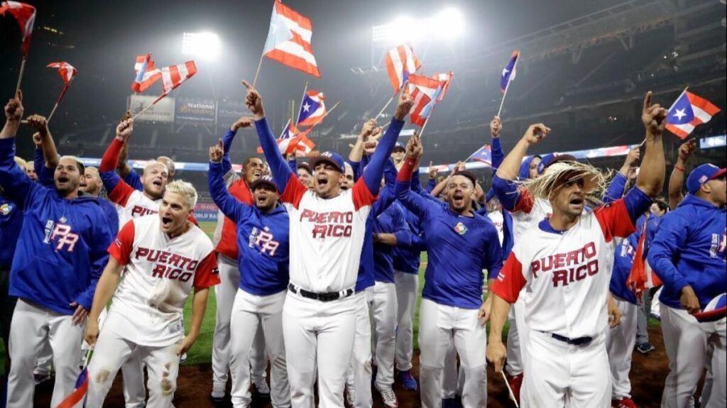 Puerto Rico national baseball team celebrating with flags at the World Baseball Classic, highlighting passion amid player restriction controversy.
