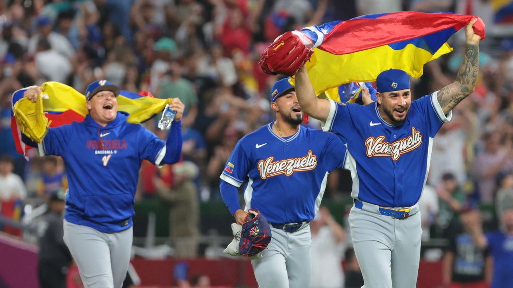 Venezuela national baseball team players celebrate with flag after winning the 2026 World Baseball Classic final vs Team USA