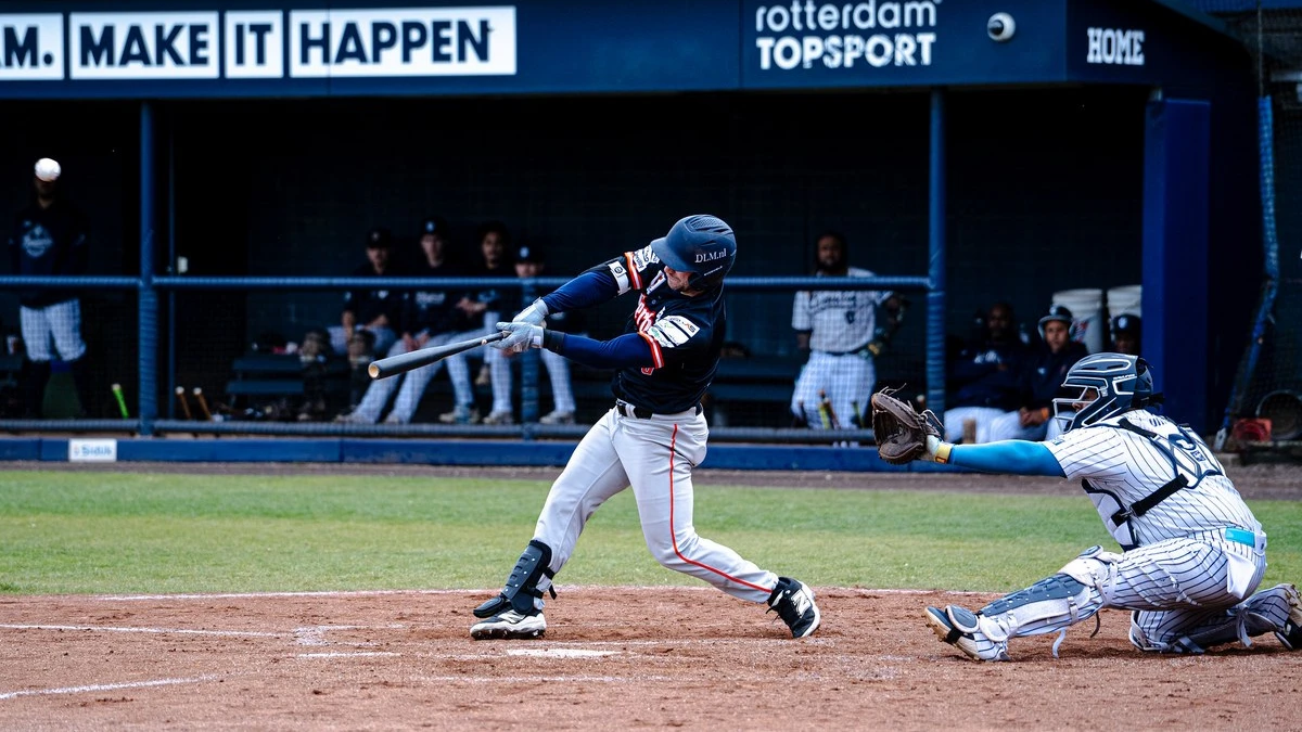 Baseball hitter connects with pitch during Oosterhout Twins vs Amsterdam Pirates game in the Dutch Hoofdklasse 2026 season