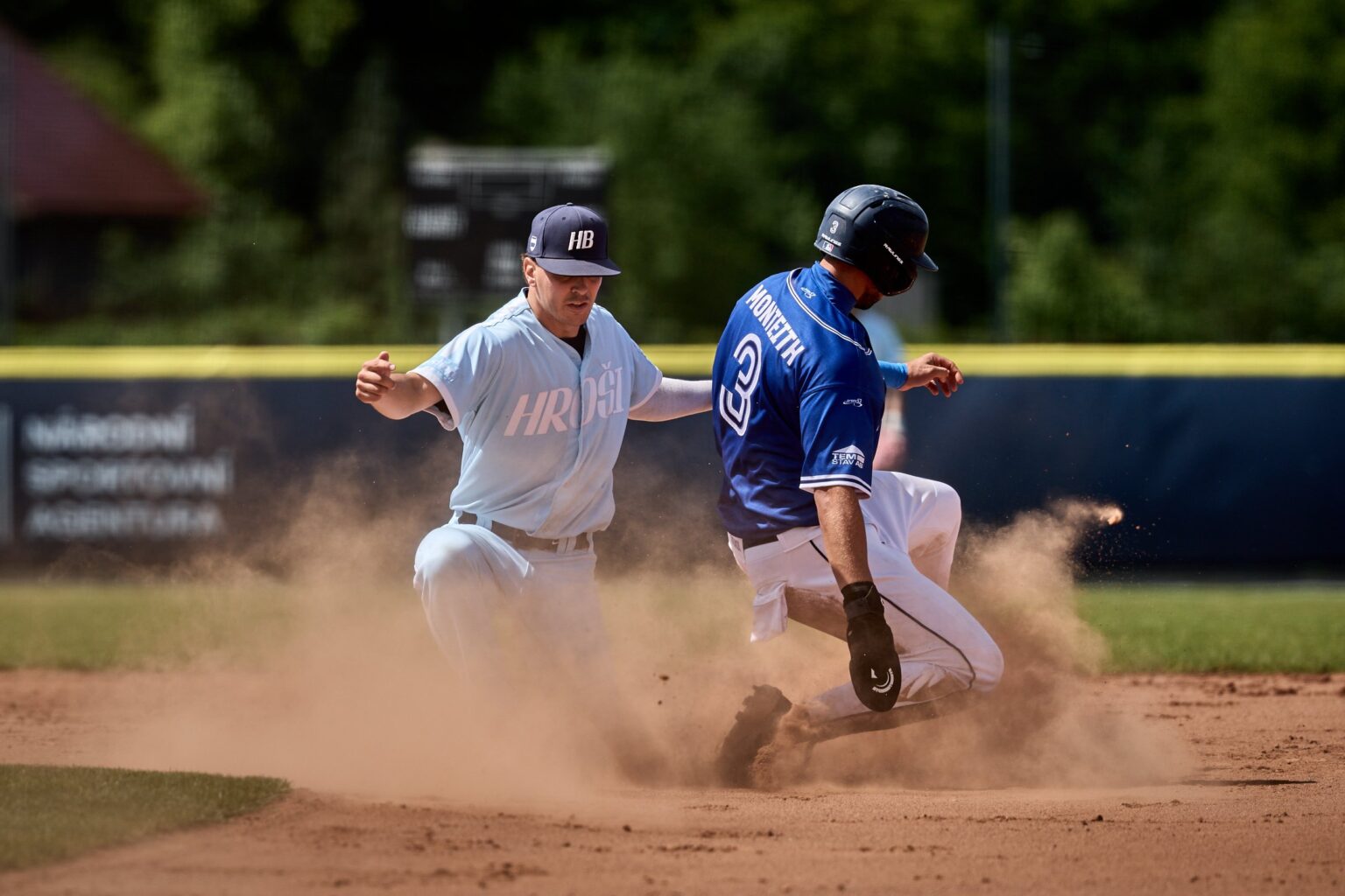 Sokol Hluboká runner slides into second base as a Hroši Brno infielder attempts the tag in the Czech Baseball Extraliga.