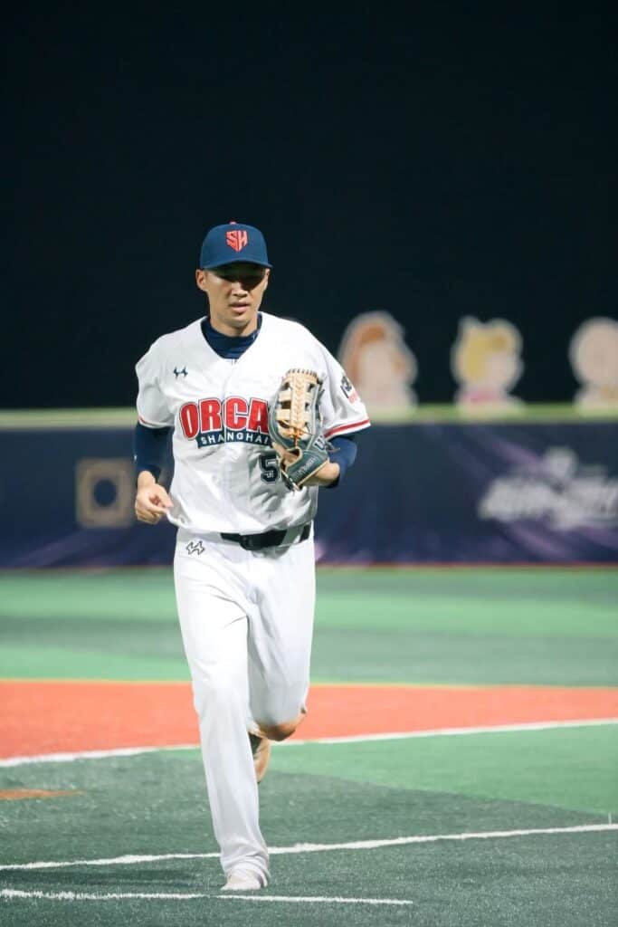 Young baseball player running on the field during a game.