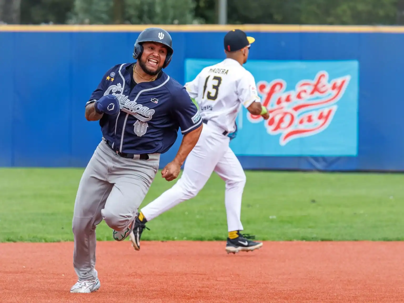 Christian Diaz of Curaçao Neptunus runs the bases with Amsterdam Pirates infielder Alex Madera in the background during the 2026 Holland Series