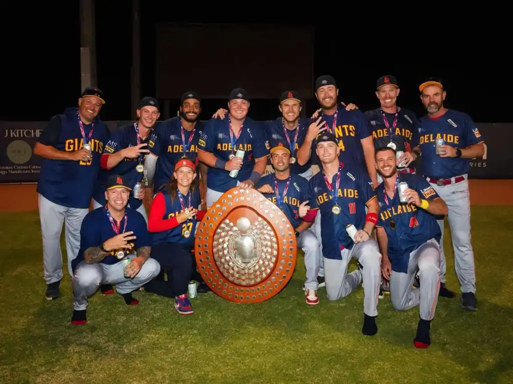 Adelaide Giants players celebrate with the Claxton Shield after winning the 2026 Australian Baseball League championship