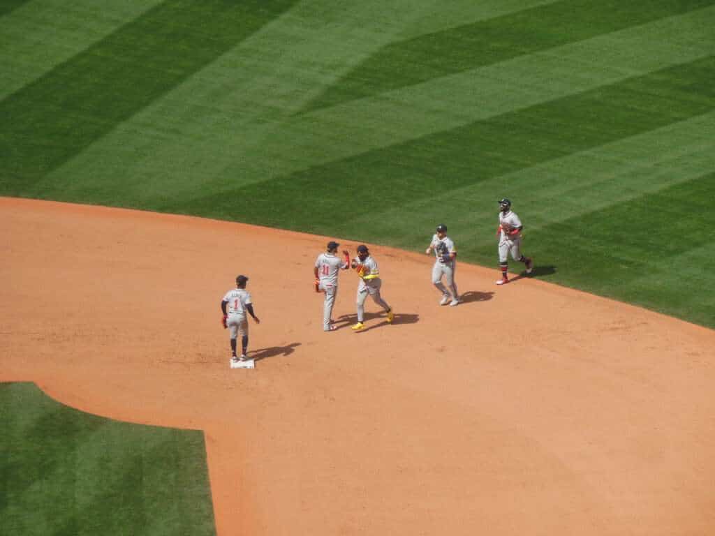 Atlanta Braves players including Ronald Acuña Jr. and Michael Harris II high-five after a road victory