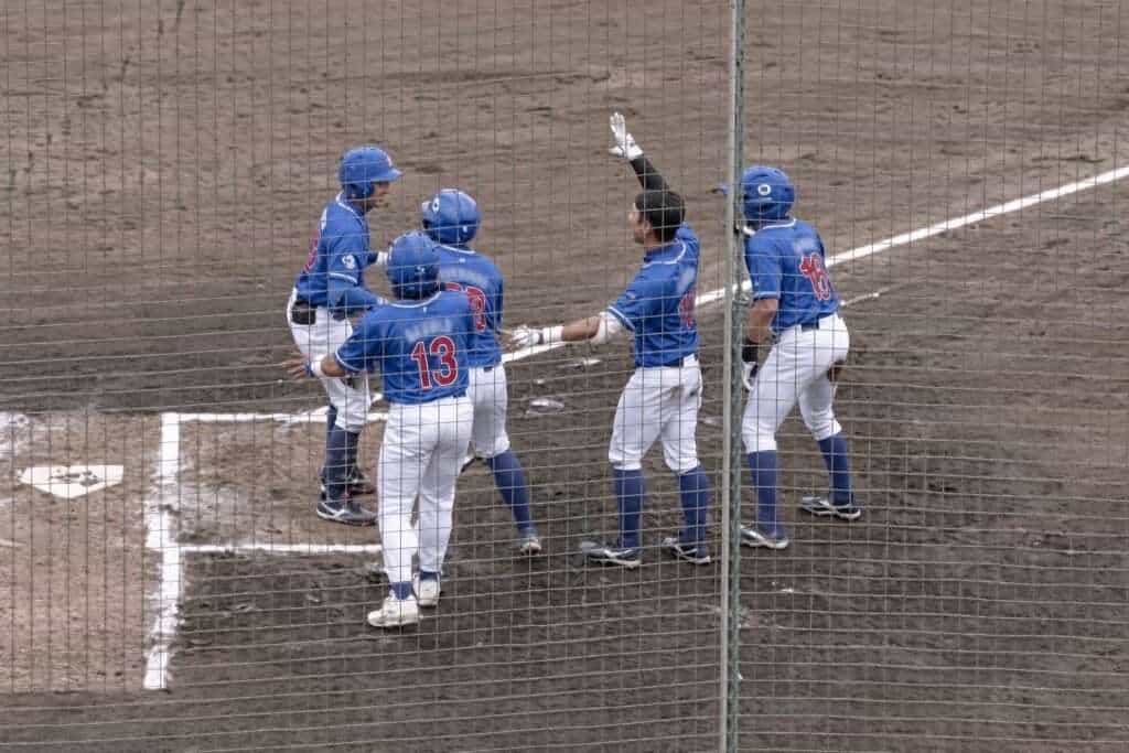 Philippines players celebrate Ferdinand Liguayan Jr. during the 2026 Asian Games baseball game against Palestine