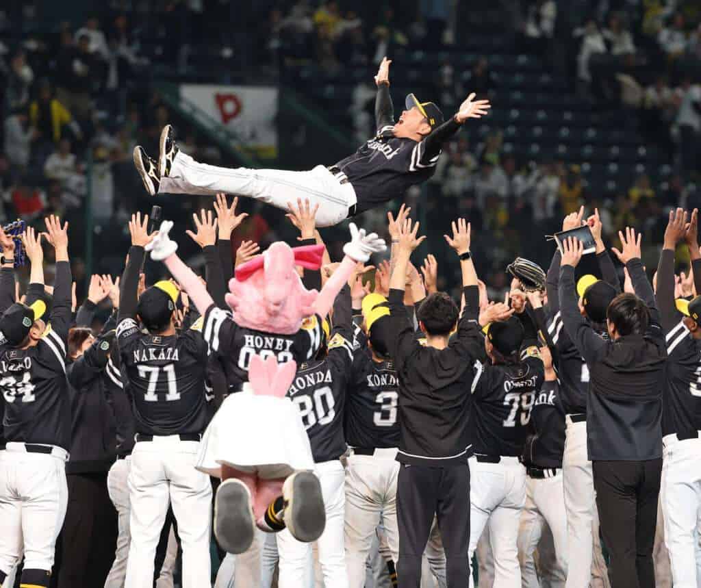 Fukuoka SoftBank Hawks celebrate a championship with manager Hiroki Kokubo lifted by players