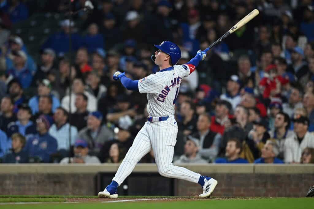 Chicago Cubs Pete Crow Armstrong follows through on a swing during a night game
