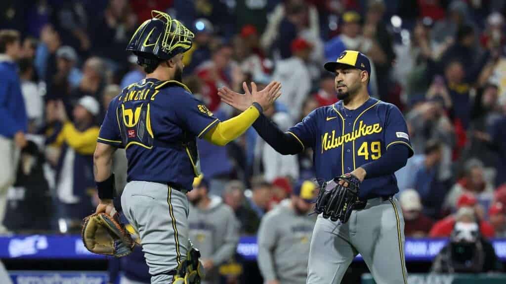 Milwaukee Brewers pitcher Antonio Senzatela and catcher Gary Sánchez celebrate the team’s 100th win against the Philadelphia Phillies
