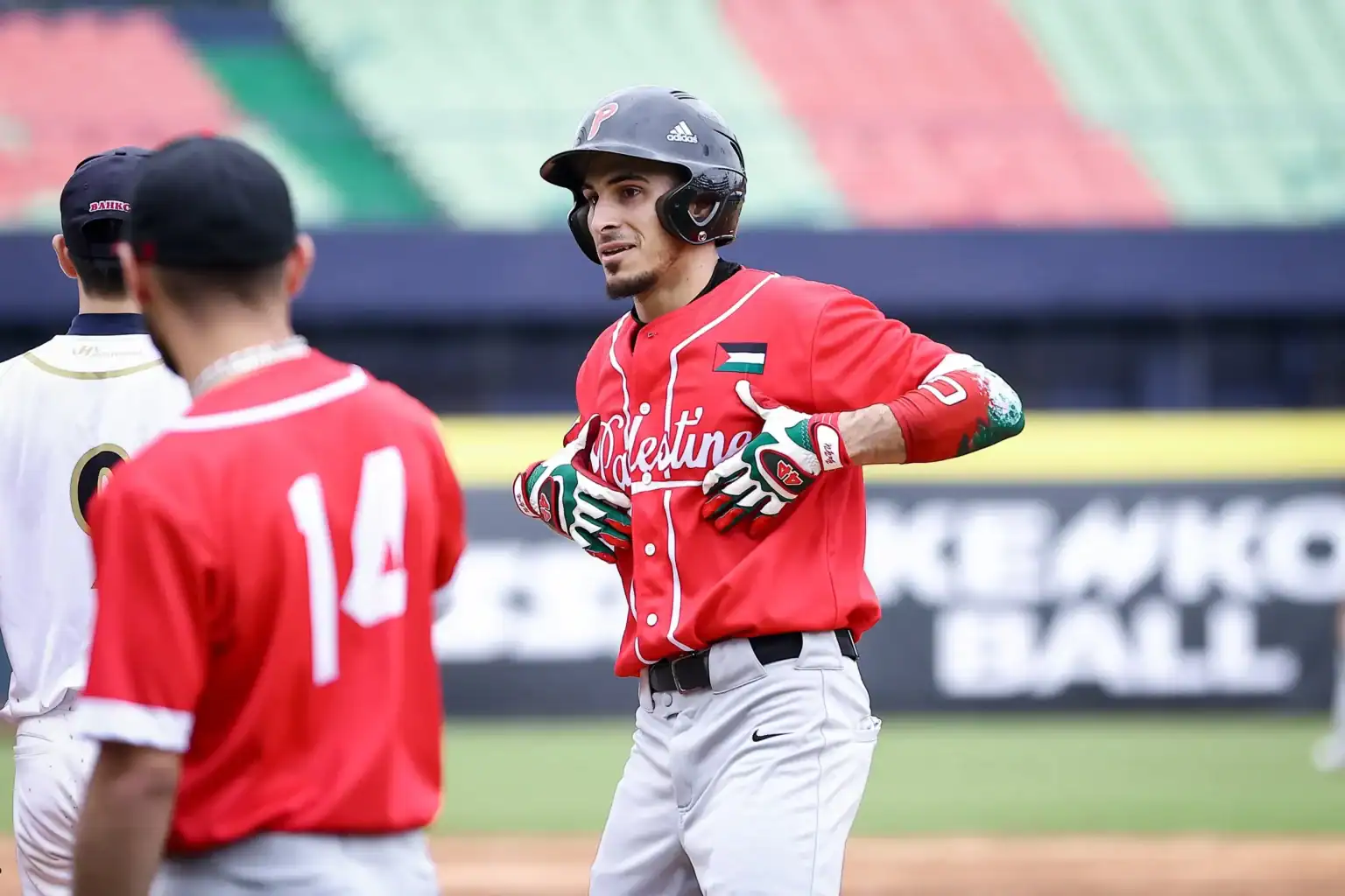 Palestine national baseball team player celebrates with teammates during international competition