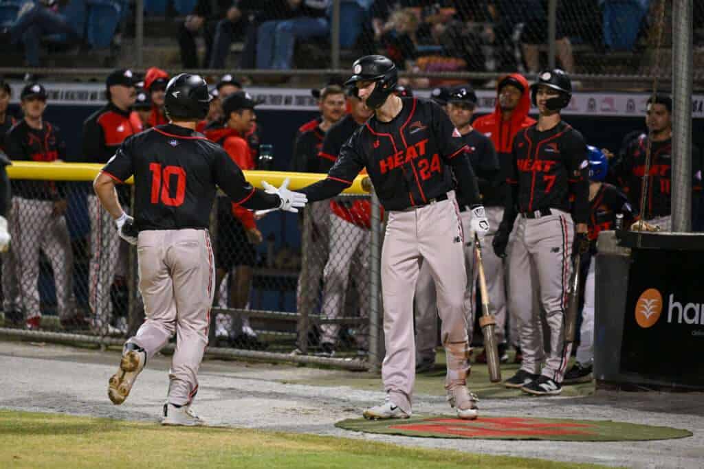 Perth Heat teammates celebrate at the dugout during a 2025–26 Australian Baseball League game