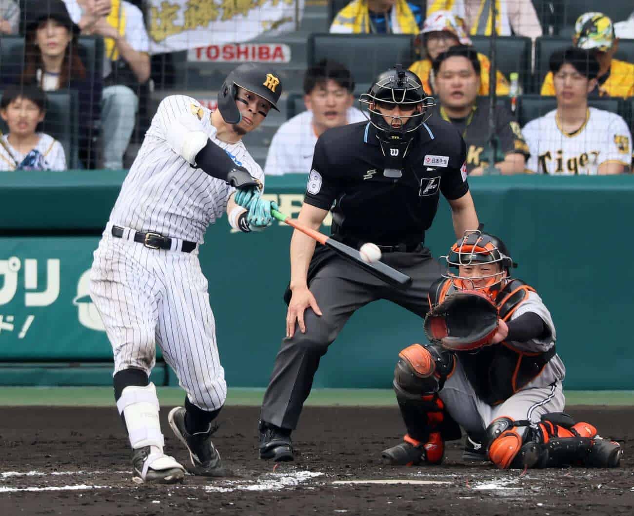 Teruaki Sato bats for the Hanshin Tigers at Koshien Stadium during the 2026 NPB season