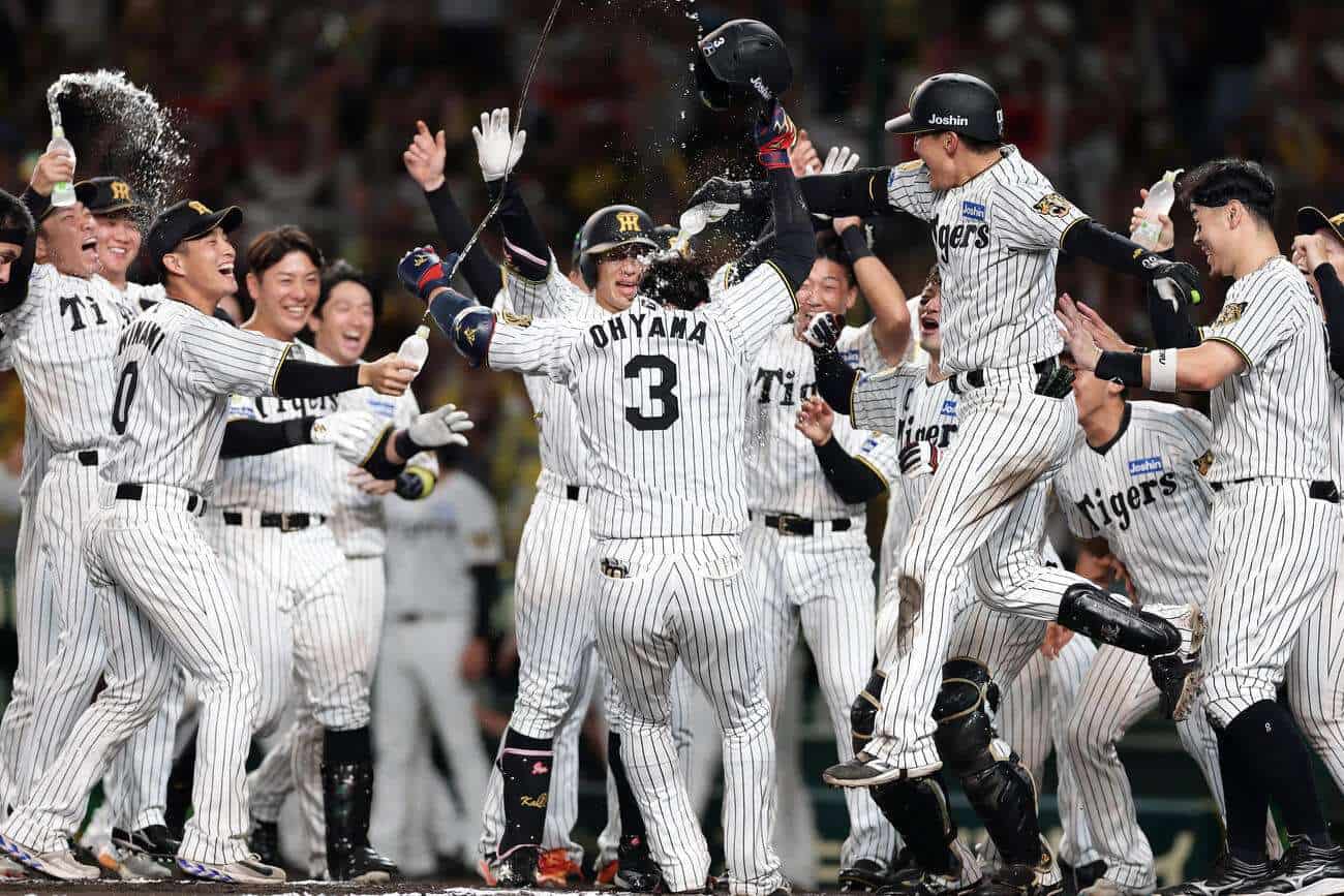 Yusuke Oyama is welcomed by Hanshin Tigers teammates after his walk-off home run against the Yokohama DeNA BayStars on September 21, 2026