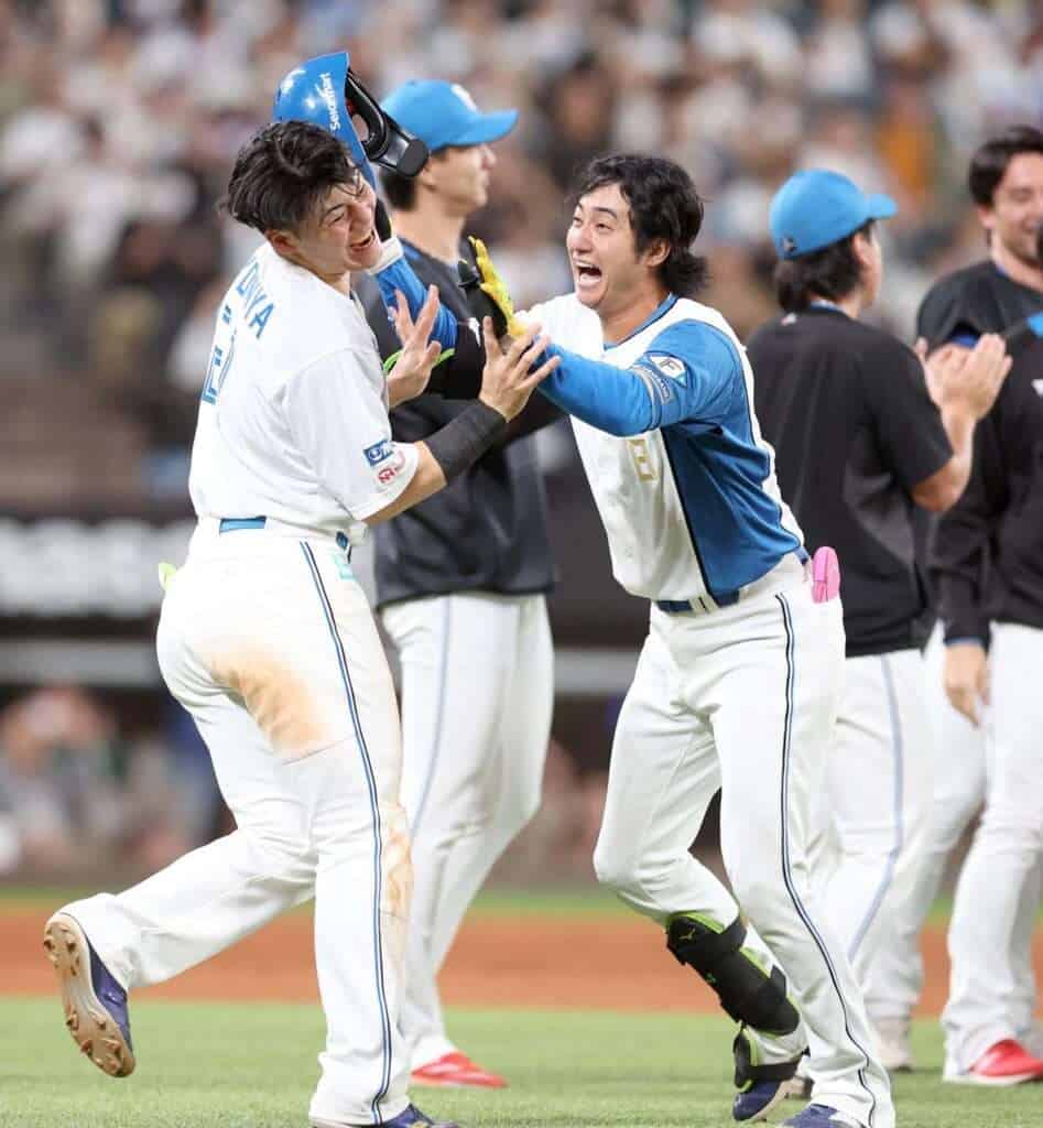 Daiki Asama celebrates with Hokkaido Nippon-Ham Fighters teammate Kotaro Kiyomiya