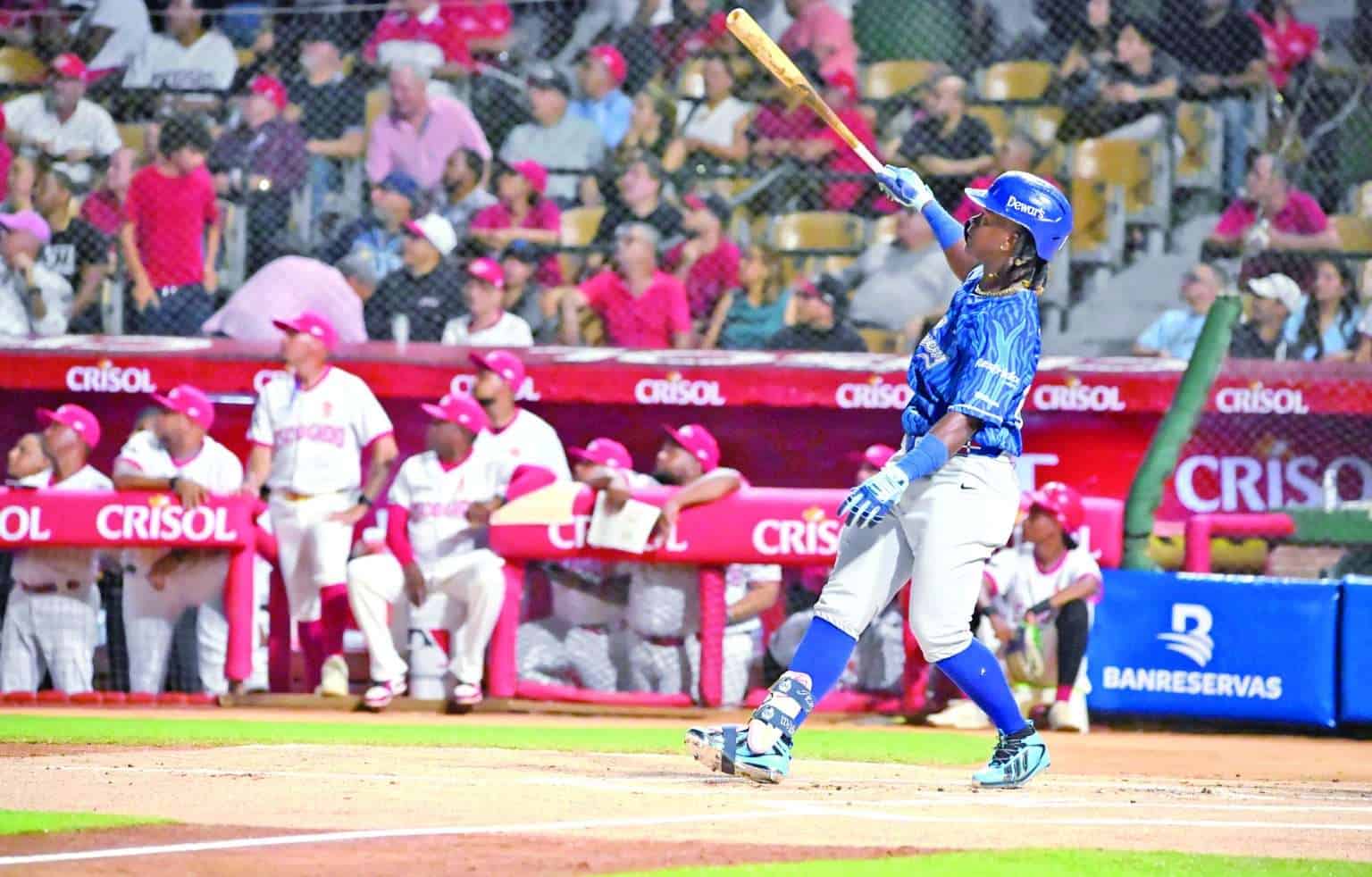 Jesús Madé follows through on his first-swing home run for Tigres del Licey against Leones del Escogido