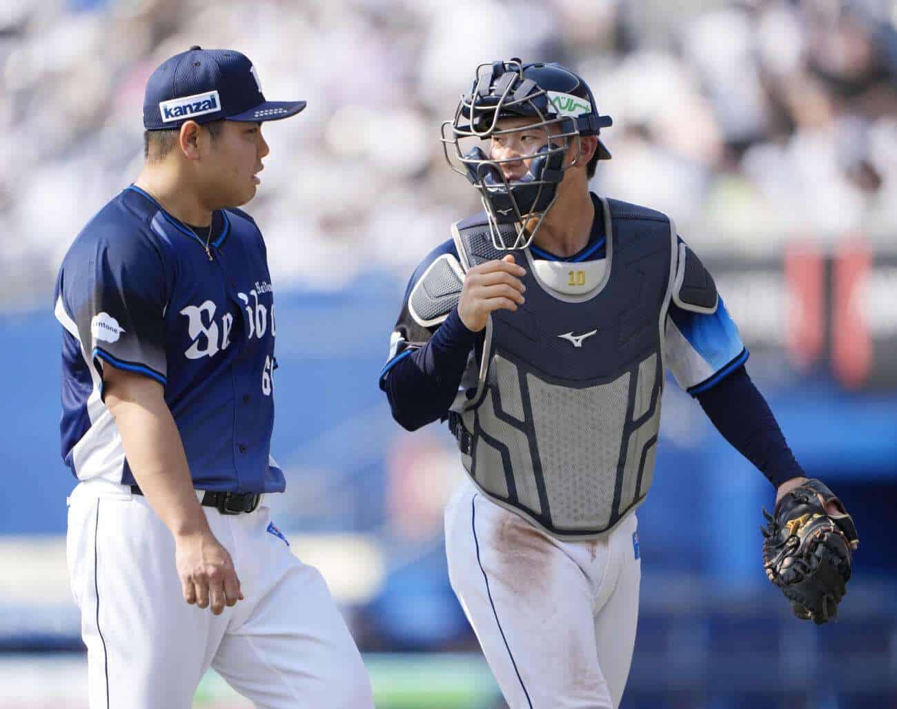 Kaima Taira and rookie catcher Taiga Kojima walk off the field together for the Saitama Seibu Lions