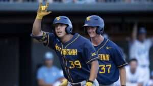 Kyle West of West Virginia signals toward the dugout during the 2024 NCAA Super Regional against North Carolina