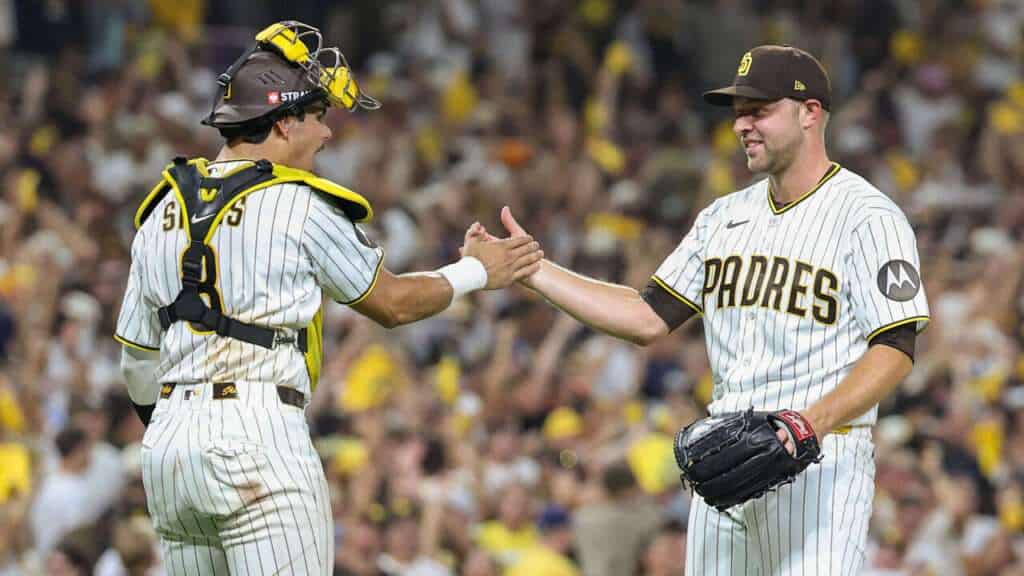 Michael King and Ethan Salas celebrate after the San Diego Padres beat the Milwaukee Brewers in NLDS Game 3