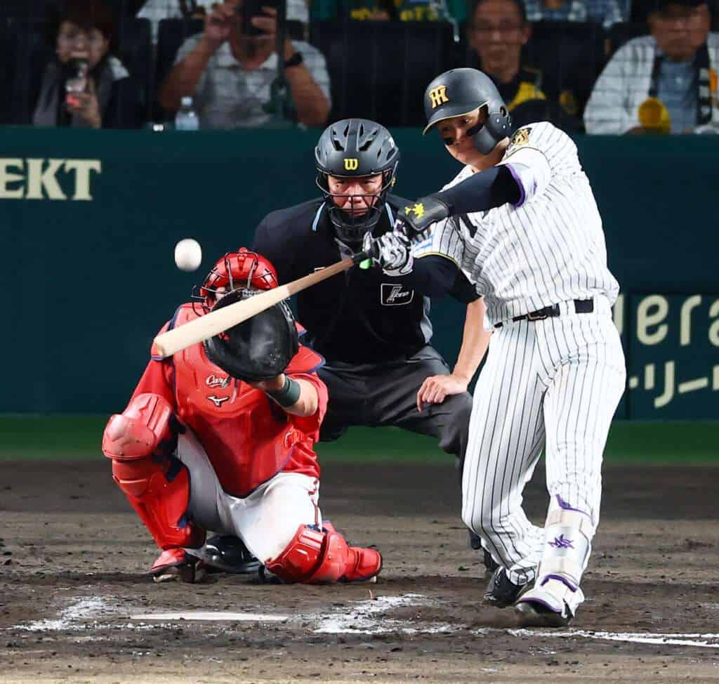 Hanshin Tigers outfielder Shota Morishita bats against the Hiroshima Carp during the 2026 NPB season